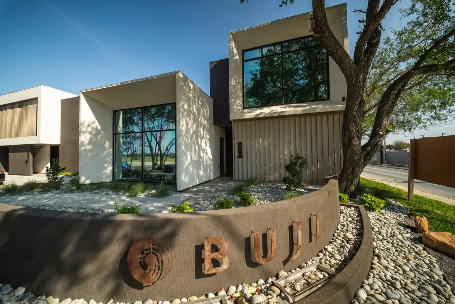 Modern residential home with a full-height tempered glass window system
